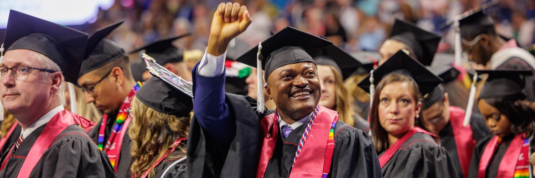 A happy graduate fist-pumps at IUSB's Commencement