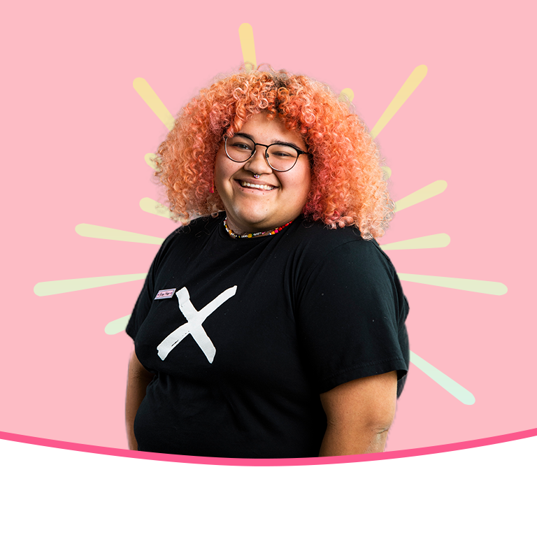 A student on a peach background with a yellow gradient burst behind the student