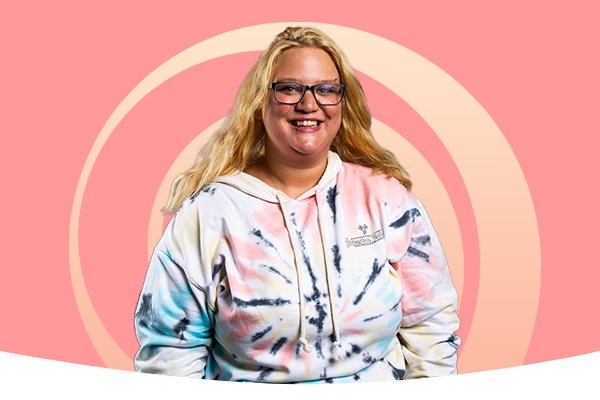 A student in front of a pink background with a gradient swirl behind her