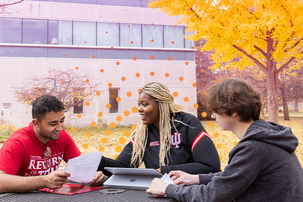 A group of students studying outside on campus